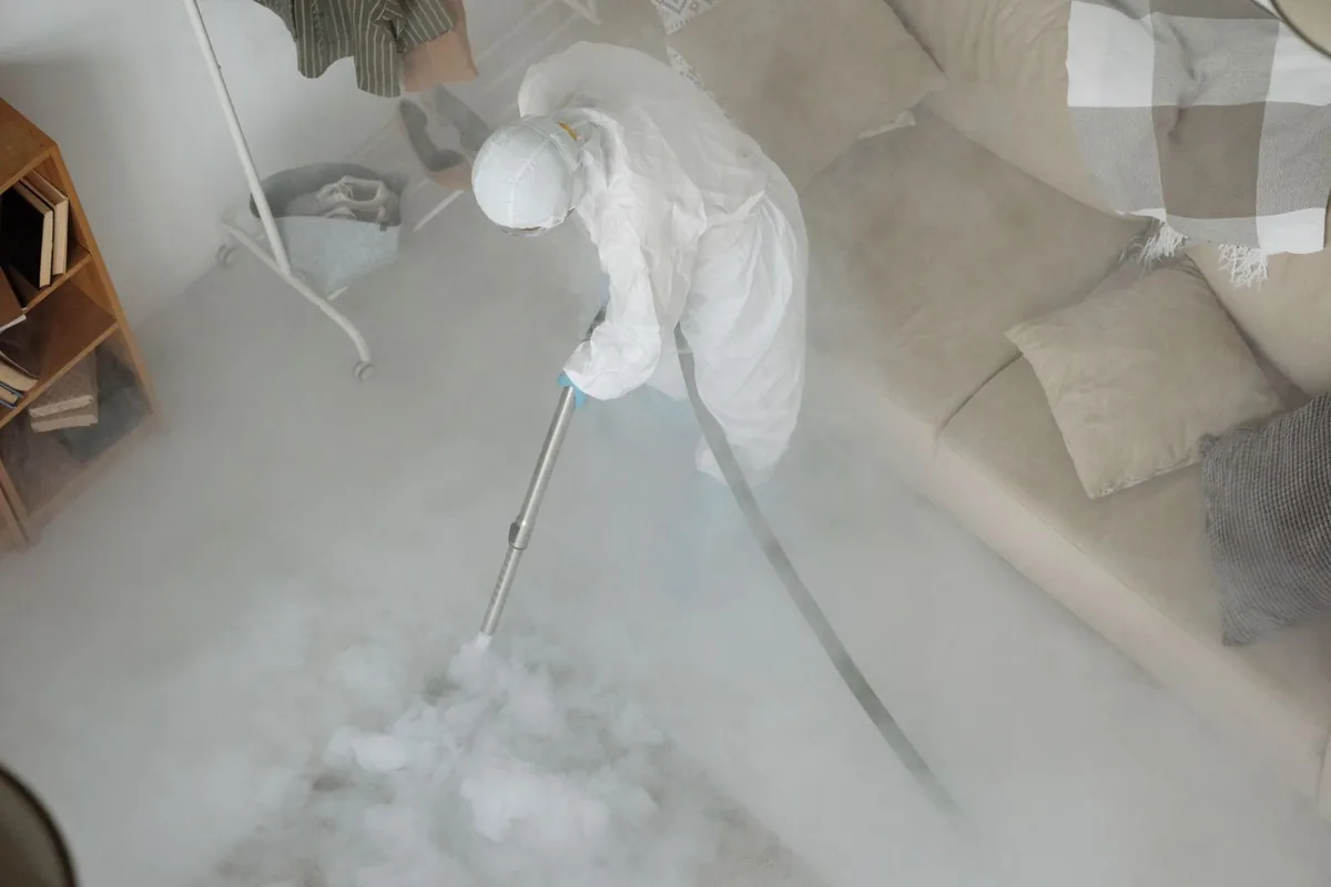 Biohazard cleanup technician in protective equipment, Scott City, KS